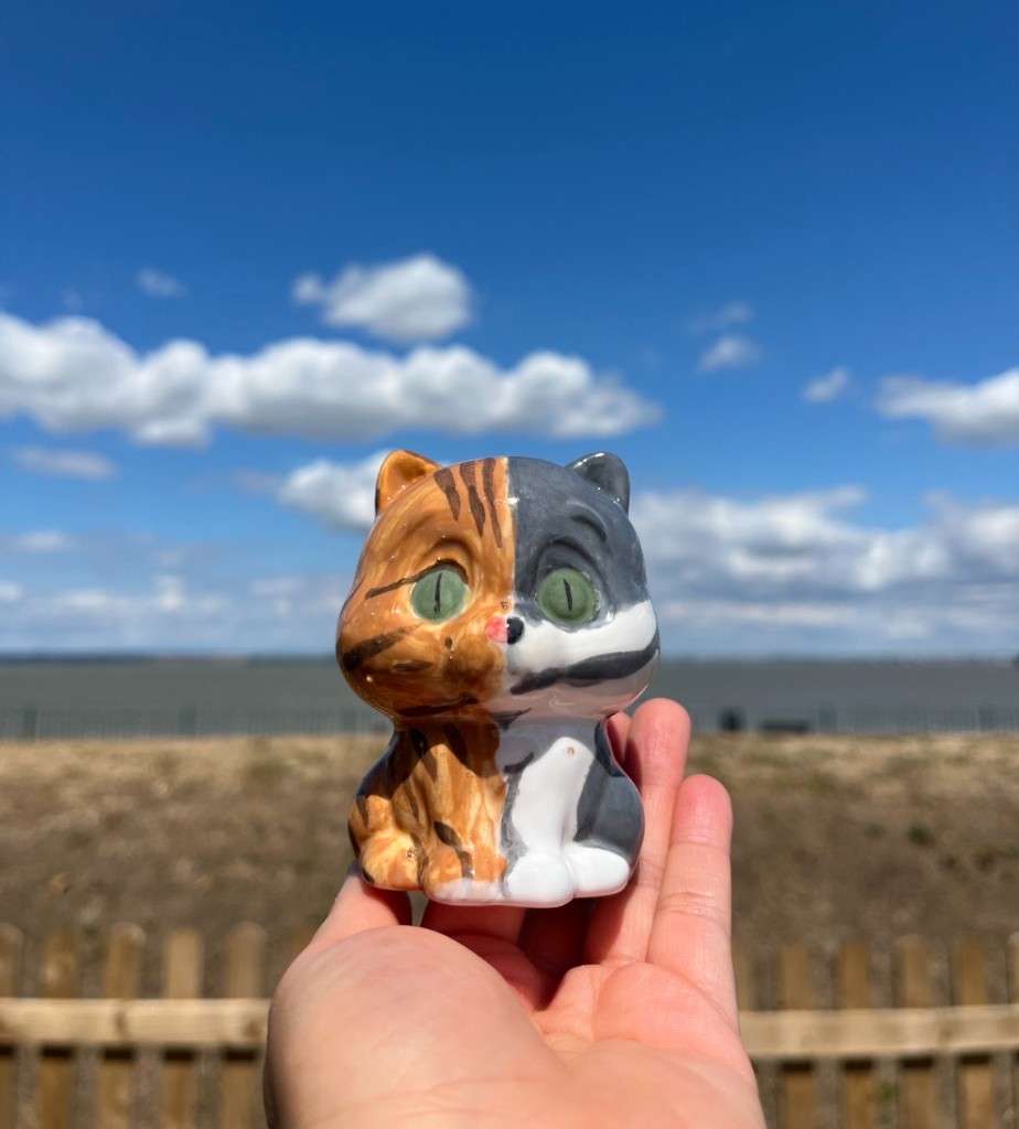 Hand-painted cat pottery figurine, ginger on one side and grey and white on the other